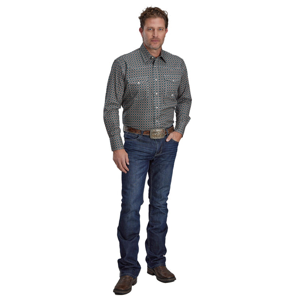 Man wearing a patterned shirt, jeans, and brown shoes on a white background