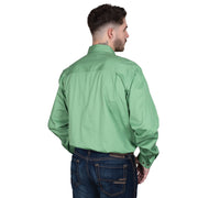 Man wearing a green shirt and dark jeans on a white background