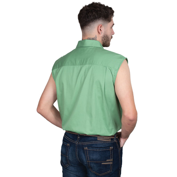 Man wearing a green sleeveless shirt and jeans on a white background