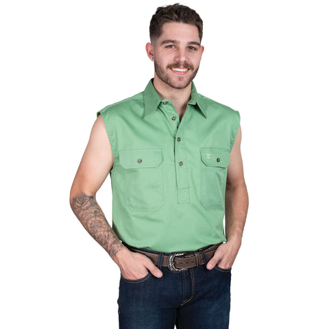 Man wearing a green sleeveless shirt and jeans on a white background