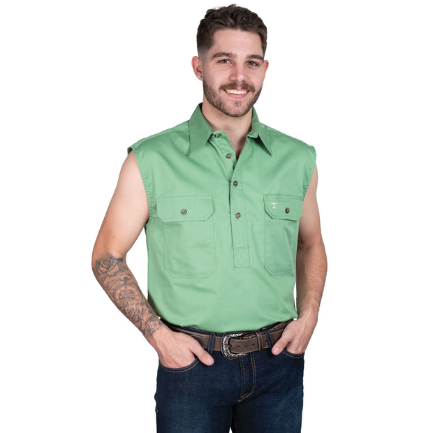 Man wearing a green sleeveless shirt and jeans on a white background