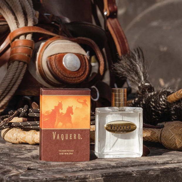 Vaquero perfume bottle and packaging on a rustic background with leather and rope.