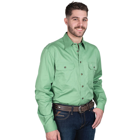 Man wearing a green shirt and blue jeans on a white background