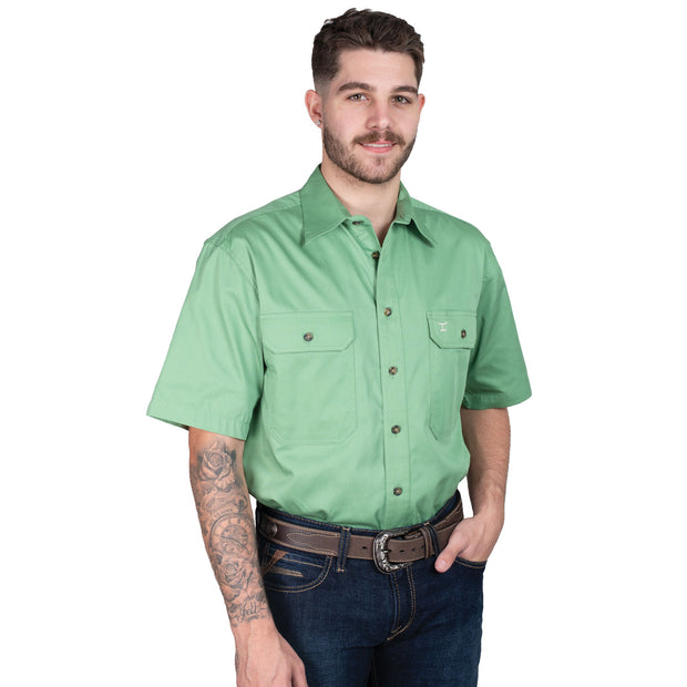 Man wearing a green short-sleeve shirt with a white background