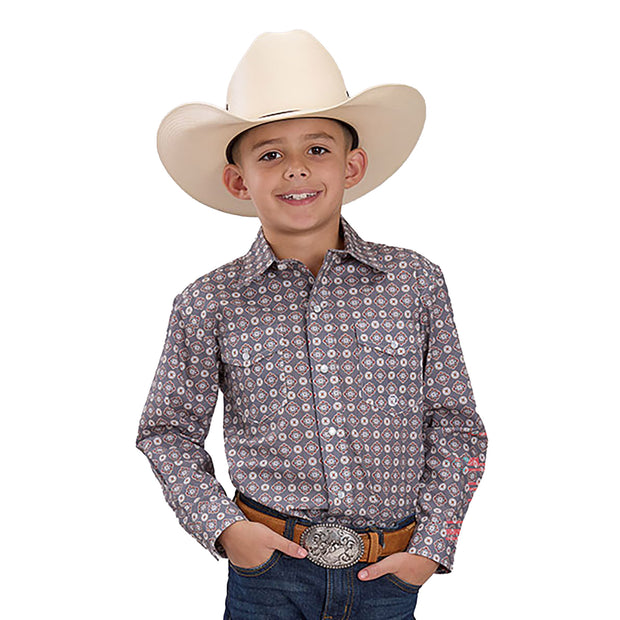 Child wearing a cowboy hat and patterned shirt on a white background