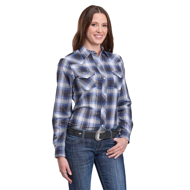 Woman wearing a blue plaid shirt and jeans on a white background