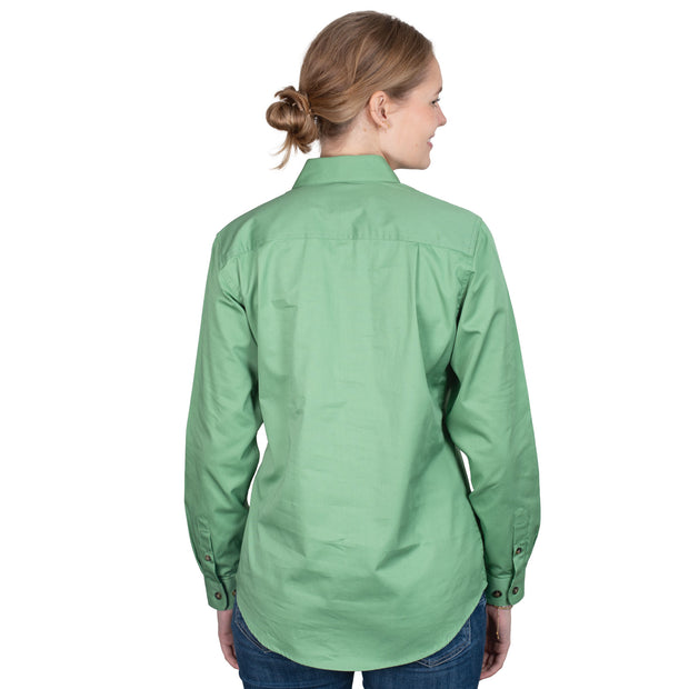 Person wearing a green shirt with a white background
