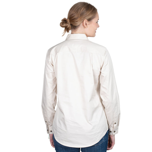 Woman wearing a white shirt with a logo on a white background
