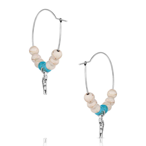 Pair of hoop earrings with bull head charms and turquoise beads on a white background