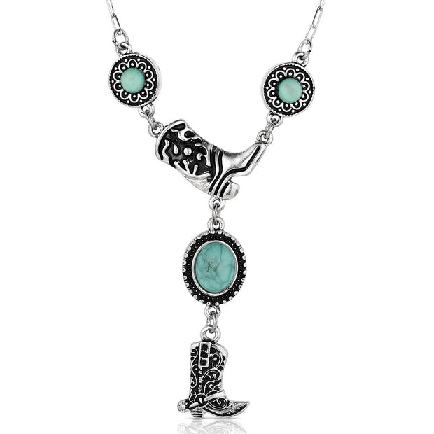 Necklace with turquoise stones and cowboy boot charm on a white background