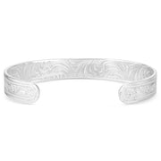 Silver bracelet with intricate designs on a white background