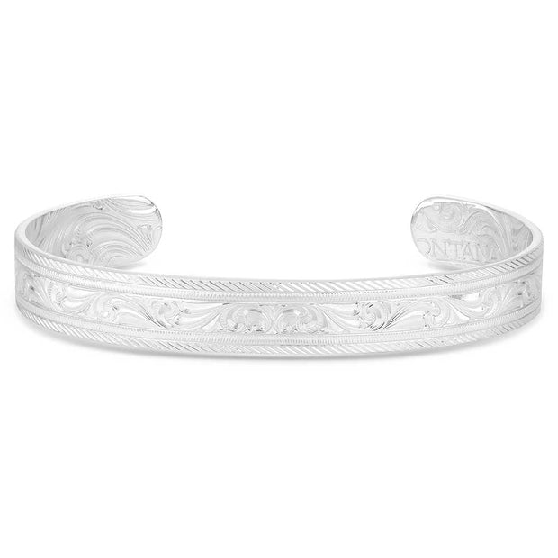 Silver bracelet with intricate designs on a white background