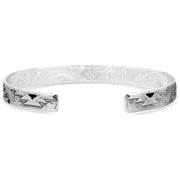 Silver bracelet with intricate designs on a white background