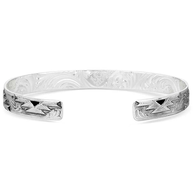 Silver bracelet with intricate designs on a white background