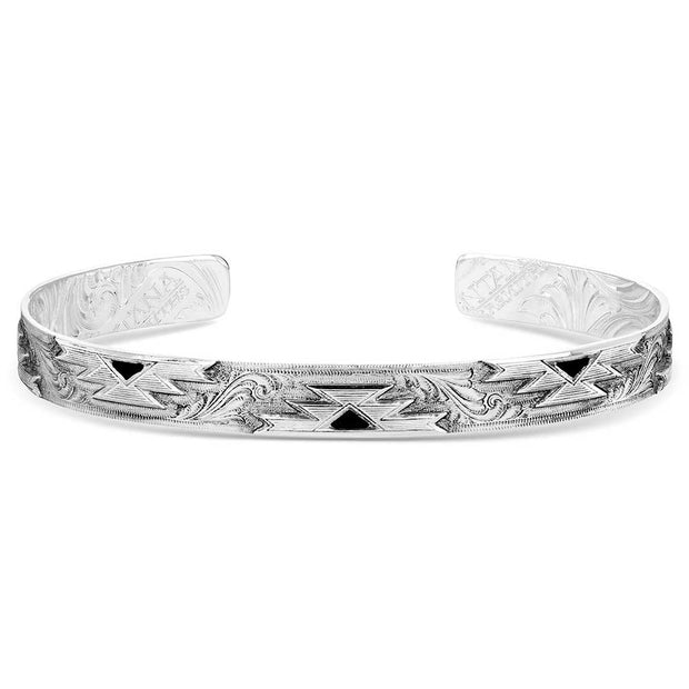 Silver bracelet with intricate patterns on a white background
