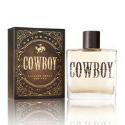 Cowboy cologne spray bottle and packaging on a white background