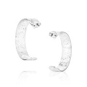 Pair of silver hoop earrings with intricate designs on a white background