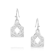 Pair of silver earrings with intricate designs on a white background
