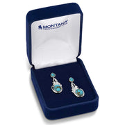 Pair of silver earrings with turquoise stones in a Montana Silversmiths box.