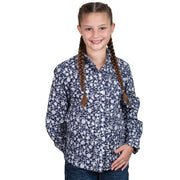 Young girl wearing a navy floral shirt on a white background