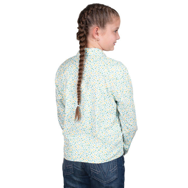 Young girl wearing a floral shirt with braided hair on a white background
