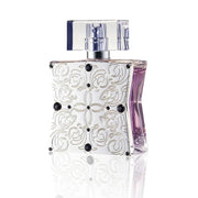 Decorative perfume bottle with intricate patterns and black accents on a white background
