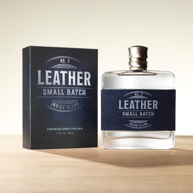 Leather cologne bottle and packaging on a beige background