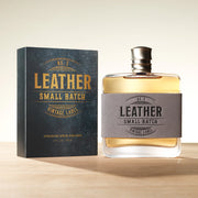 Bottle and packaging of 'Leather Small Batch' cologne on a wooden surface with a light background