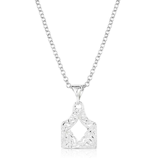 Silver necklace with a detailed pendant on a white background