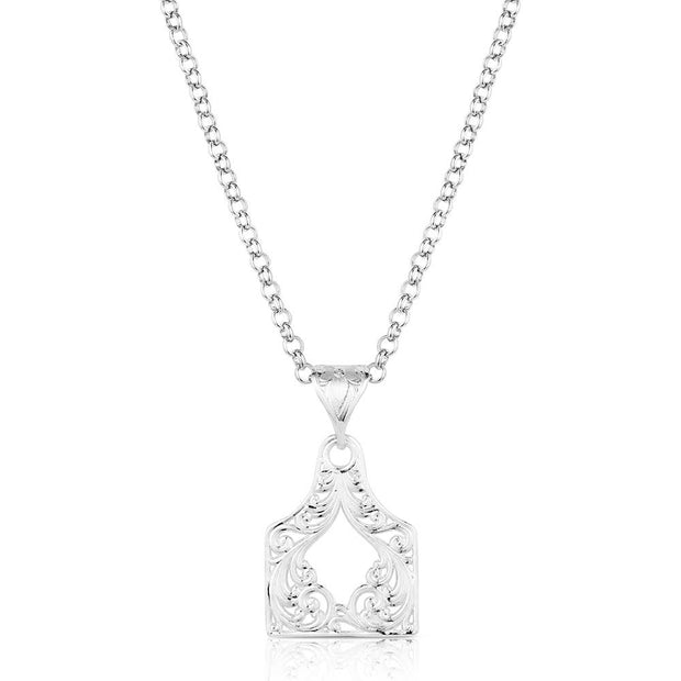 Silver necklace with a detailed pendant on a white background