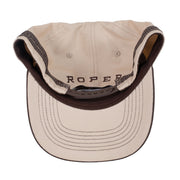Brown and beige cap with a logo on a white background