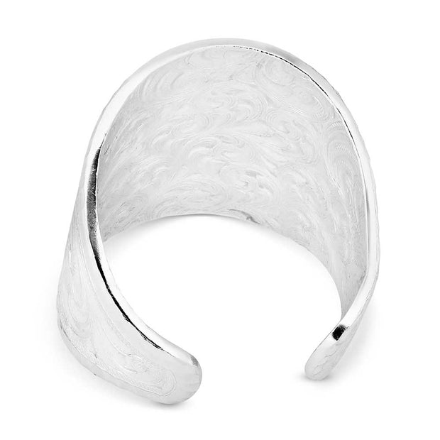 Silver cuff bracelet with intricate floral patterns on a white background