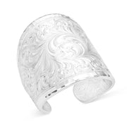 Silver cuff bracelet with intricate floral patterns on a white background