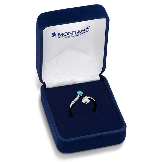 Silver ring with gemstones in a blue jewelry box with 'Montana Silversmiths' branding.