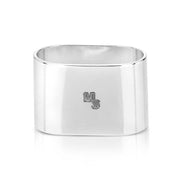 Silver napkin ring with 'MS' engraving on a white background