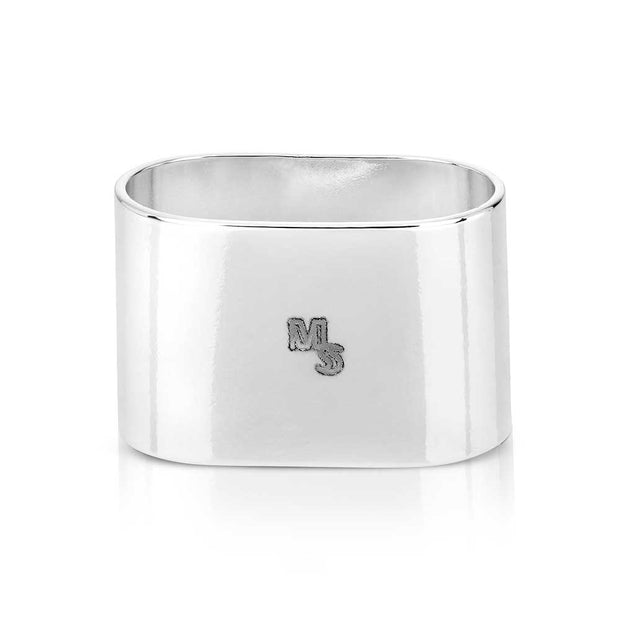 Silver napkin ring with 'MS' engraving on a white background