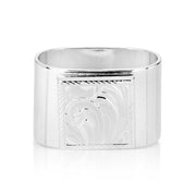 Silver cuff bracelet with engraved design on a white background