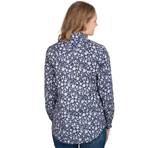 Woman wearing a floral patterned shirt on a white background