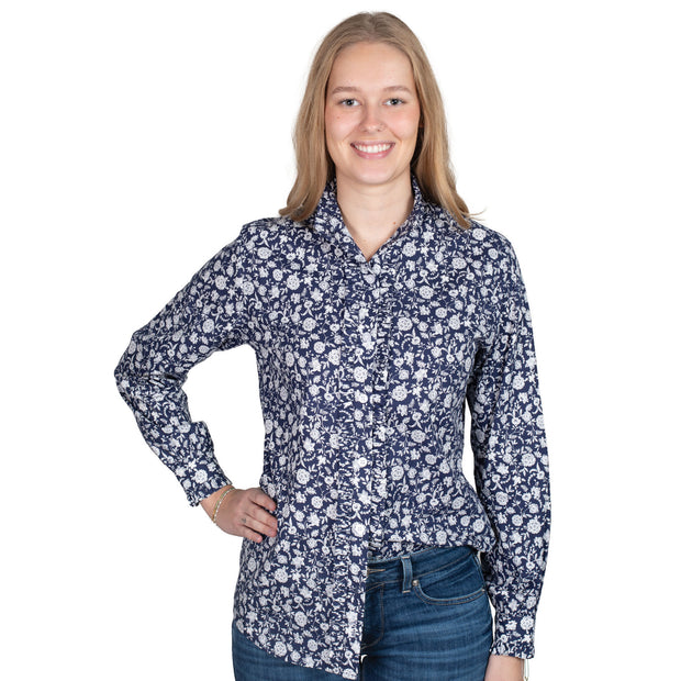 Woman wearing a floral patterned shirt on a white background