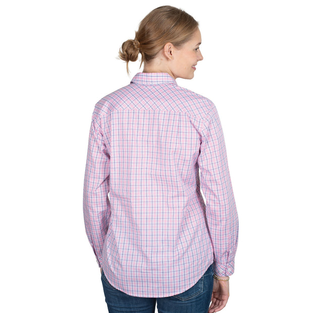 Woman wearing a pink checkered shirt and blue jeans on a white background