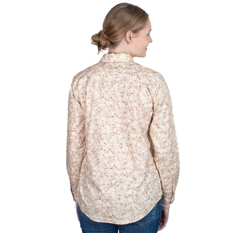 Woman wearing a beige floral shirt on a white background