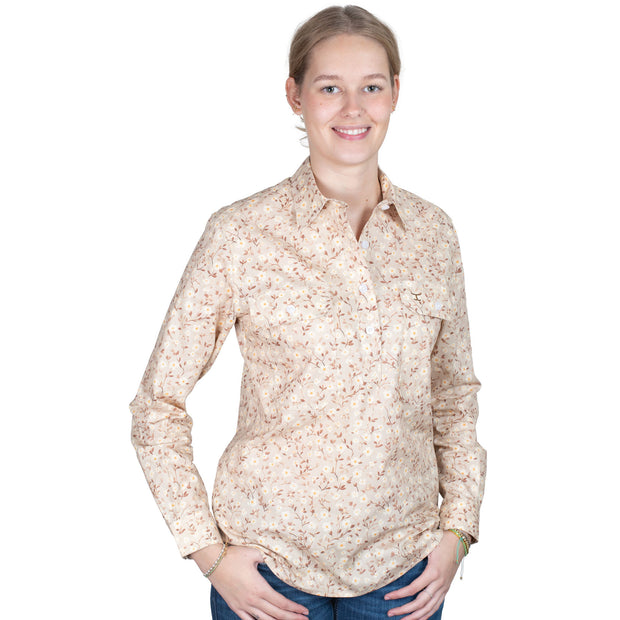 Woman wearing a beige floral shirt on a white background