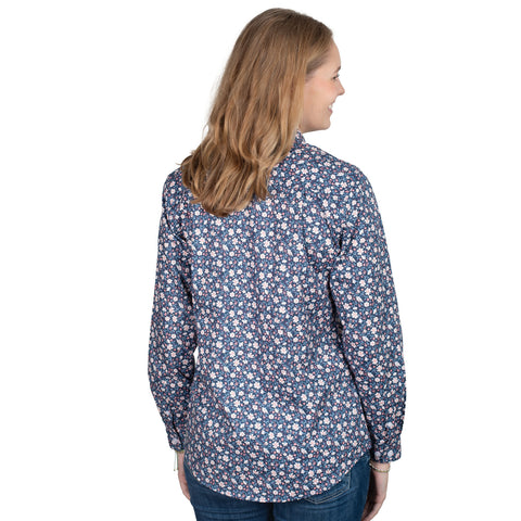 Woman wearing a blue floral shirt on a white background