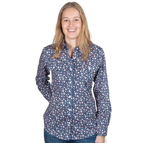 Woman wearing a blue floral shirt on a white background