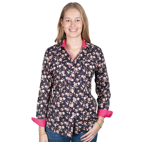 Woman wearing a floral patterned shirt with pink accents on a white background