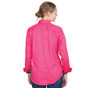 Woman wearing a bright pink shirt with floral cuffs on a white background