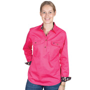 Woman wearing a bright pink shirt with floral cuffs on a white background