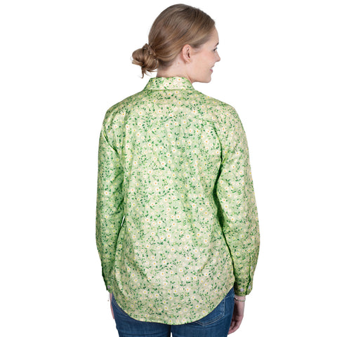 Woman wearing a green floral shirt on a white background