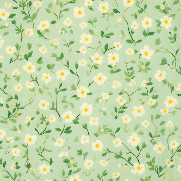 Pattern of small white flowers with green leaves on a light green background