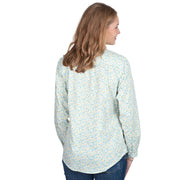 Woman wearing a floral shirt on a white background
